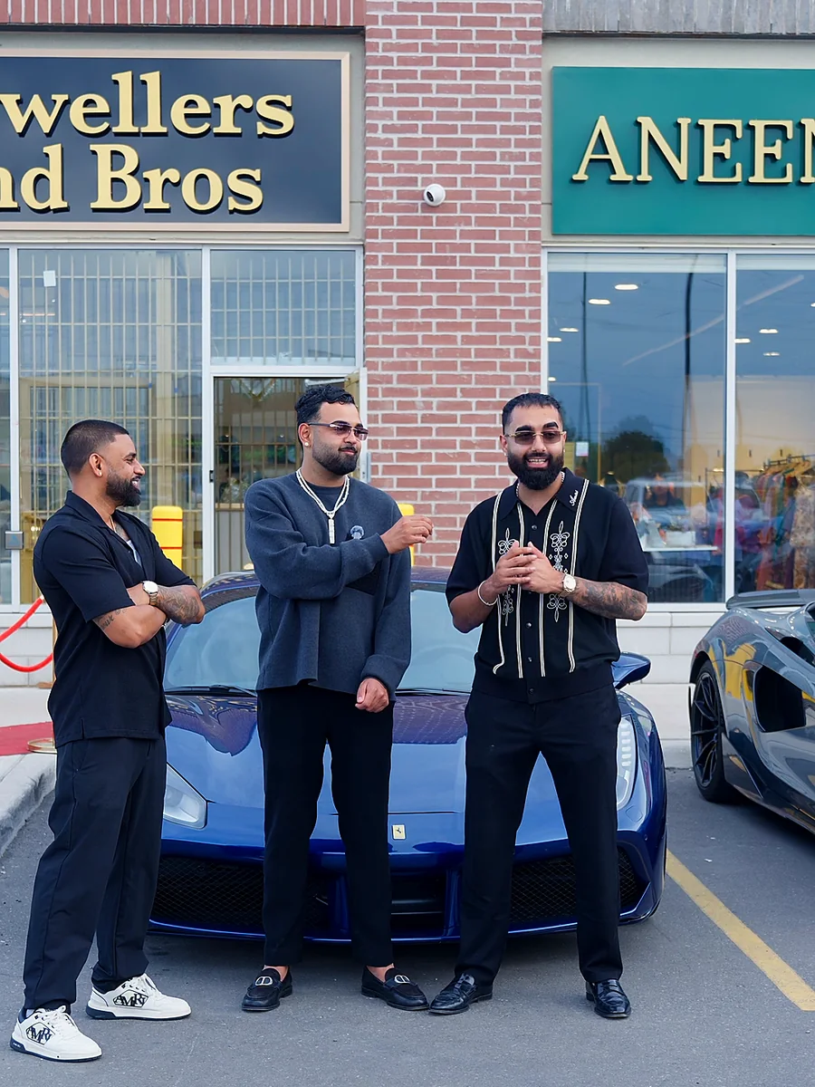 Matthew Betop with the two owners in front of their Ferrari at the opening of their third store